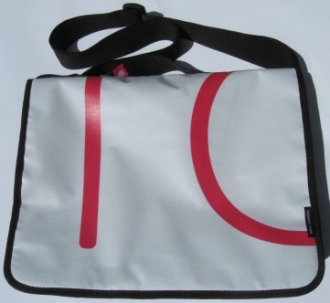 A recycled laptop bag made from Powershop's Electricity vs Power billboard campaign.